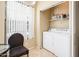 A well-lit laundry area featuring a washer and dryer next to a window at 14950 W Mountain View Blvd # 7209, Surprise, AZ 85374