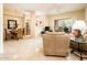 Inviting living room with neutral tones and a dining area, perfect for entertaining at 14950 W Mountain View Blvd # 7209, Surprise, AZ 85374