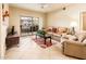 Comfortable living room with a plush sofa, balcony access, and ample natural light at 14950 W Mountain View Blvd # 7209, Surprise, AZ 85374