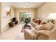 Cozy living room features a sliding glass door that brings in natural light and fresh air at 14950 W Mountain View Blvd # 7209, Surprise, AZ 85374