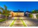 Charming backyard with professional lighting and landscaping, bocce ball court, and outdoor dining area with seating at 1513 E Sheridan St, Phoenix, AZ 85006