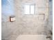 Modern bathtub with white marble surround and convenient soap and shampoo dispensers at 1513 E Sheridan St, Phoenix, AZ 85006