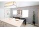 Dining area with long wood table, decorative wallpaper, and bright natural light at 1513 E Sheridan St, Phoenix, AZ 85006