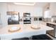 Modern kitchen featuring white cabinets, stainless steel appliances, and a sleek center island with seating at 1513 E Sheridan St, Phoenix, AZ 85006