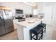 Modern kitchen featuring white cabinets, stainless steel appliances, and a sleek center island with seating at 1513 E Sheridan St, Phoenix, AZ 85006