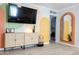 Bright living room showcasing a woven cabinet, decorative mirror, and artistic painted design at 1513 E Sheridan St, Phoenix, AZ 85006