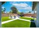 View of the backyard, featuring artificial lawn, a firepit area with chairs and a trailer behind a wood fence at 1531 S Padre Rd, Apache Junction, AZ 85119