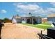 Backyard with an artificial lawn, a covered patio, an outbuilding, and a trailer at 1531 S Padre Rd, Apache Junction, AZ 85119