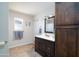 Bathroom featuring dark vanity, storage cabinet, tile floors, and great lighting at 1531 S Padre Rd, Apache Junction, AZ 85119