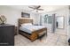 Bright bedroom featuring a wooden bed frame, tile flooring, and a ceiling fan at 1531 S Padre Rd, Apache Junction, AZ 85119