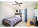 Cozy bedroom with wood frame bed, ceiling fan, and natural light from the window at 1531 S Padre Rd, Apache Junction, AZ 85119