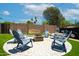 Circular brick-laid outdoor firepit area featuring matching chairs surrounding the area on an artificial lawn at 1531 S Padre Rd, Apache Junction, AZ 85119