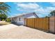 Low maintenance home boasts a private gated drive, desert landscaping, and a neutral-tone exterior at 1531 S Padre Rd, Apache Junction, AZ 85119
