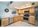 Bright kitchen featuring wooden cabinetry, stainless steel appliances, and a skylight at 1531 S Padre Rd, Apache Junction, AZ 85119