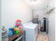 Functional laundry room with white washer, dryer, and organized storage shelves at 1531 S Padre Rd, Apache Junction, AZ 85119