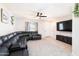Spacious living room features carpet flooring, a black leather sectional, and a ceiling fan at 1531 S Padre Rd, Apache Junction, AZ 85119