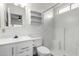 All-white bathroom with vinyl shower, shelves, toilet and sink at 1784 E Torrey Pines Ln, Chandler, AZ 85249