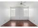 Empty bedroom showcasing new flooring, natural light, white walls and ceiling fan at 1784 E Torrey Pines Ln, Chandler, AZ 85249