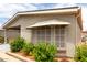 Exterior shot of home with awning over window and manicured shrubs at 1784 E Torrey Pines Ln, Chandler, AZ 85249