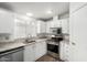 Bright kitchen featuring white cabinetry, stainless steel appliances and modern countertops at 1784 E Torrey Pines Ln, Chandler, AZ 85249