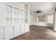 Bright living room features built-in storage, wood floors and a ceiling fan at 1784 E Torrey Pines Ln, Chandler, AZ 85249