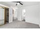 Spacious main bedroom featuring neutral walls, carpet, ceiling fan, ensuite bathroom and walk in closet at 1784 E Torrey Pines Ln, Chandler, AZ 85249