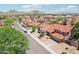 An aerial shot captures a neighborhood showcasing homes with red tile roofs and desert landscaping with mountain views at 1813 E Sheena Dr, Phoenix, AZ 85022