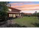 Charming home offers a covered patio, grassy yard, and beautiful sunset views at 1813 E Sheena Dr, Phoenix, AZ 85022