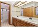 Well-lit bathroom featuring a double sink vanity with tile countertop and tile floor at 1813 E Sheena Dr, Phoenix, AZ 85022