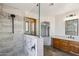 Modern bathroom boasts a glass-enclosed shower with elegant tile work and a wood vanity at 1813 E Sheena Dr, Phoenix, AZ 85022