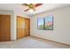 Bedroom featuring neutral carpet, ceiling fan, standard window, and double door closet at 1813 E Sheena Dr, Phoenix, AZ 85022
