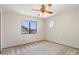 Bedroom featuring neutral carpet, ceiling fan, round window, and standard window at 1813 E Sheena Dr, Phoenix, AZ 85022