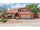 Charming home featuring a red tile roof, a two-car garage, and desert landscaping in the front yard at 1813 E Sheena Dr, Phoenix, AZ 85022