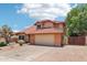 Charming home featuring a red tile roof, a two-car garage, and desert landscaping in the front yard at 1813 E Sheena Dr, Phoenix, AZ 85022