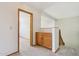 Hallway with wooden cabinets and an open doorway to another room at 1813 E Sheena Dr, Phoenix, AZ 85022