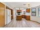 Open kitchen with tile floors, an island and wooden cabinets, perfect for cooking at 1813 E Sheena Dr, Phoenix, AZ 85022