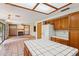 Kitchen with center island, oak cabinets, and tile flooring at 1813 E Sheena Dr, Phoenix, AZ 85022