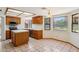 Charming kitchen with wooden cabinets, tile countertops, and abundant natural light at 1813 E Sheena Dr, Phoenix, AZ 85022