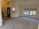 Bright living area with cozy carpet and large window with roller blinds and staircase at 1813 E Sheena Dr, Phoenix, AZ 85022