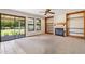 Bright Living Room with Fireplace, Bookshelves, and Sliding Door to Backyard at 1813 E Sheena Dr, Phoenix, AZ 85022