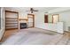 Cozy living room with a fireplace, built-in bookshelves, and large windows at 1813 E Sheena Dr, Phoenix, AZ 85022