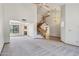Open living room featuring a winding staircase, large windows, and neutral carpet at 1813 E Sheena Dr, Phoenix, AZ 85022