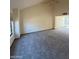 Spacious carpeted living room with high vaulted ceilings, bright windows, and neutral paint at 1813 E Sheena Dr, Phoenix, AZ 85022