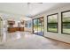 Open living space features tile flooring, kitchen access, and sliding glass doors at 1813 E Sheena Dr, Phoenix, AZ 85022