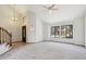 Bright living room featuring carpet floors, high ceilings, and large windows providing ample natural light at 1813 E Sheena Dr, Phoenix, AZ 85022