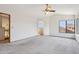 Large primary bedroom with neutral carpet, vaulted ceiling, and neighborhood view at 1813 E Sheena Dr, Phoenix, AZ 85022