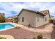 Exterior backyard of house featuring an in-ground pool, rock landscaping, tile roof, and exterior view at 18614 E Oriole Way, Queen Creek, AZ 85142