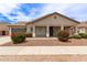 Inviting single-story home showcasing lovely desert landscaping and a cozy, covered front porch at 18614 E Oriole Way, Queen Creek, AZ 85142