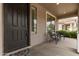 Inviting front porch featuring outdoor seating and a welcoming entrance at 18614 E Oriole Way, Queen Creek, AZ 85142
