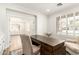 View of a home office with custom shelving, wood desk, and ample natural light at 18614 E Oriole Way, Queen Creek, AZ 85142